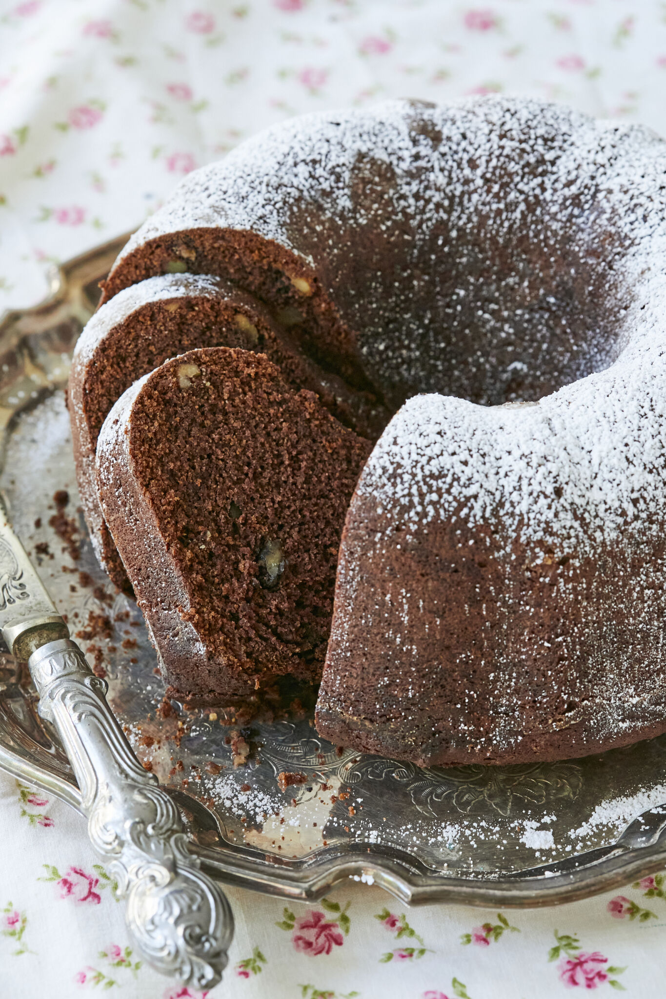 Homemade applesauce cake, filled with walnuts, and dusted with powdered sugar. 