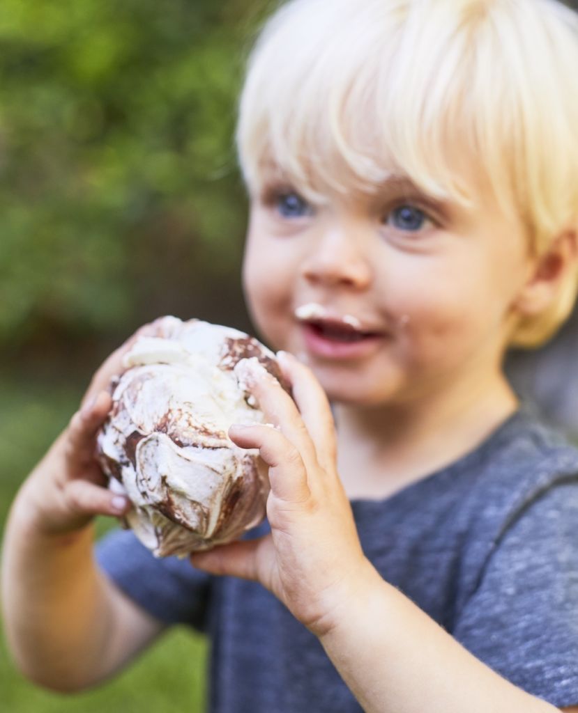 A young boy with a cinnamon roll