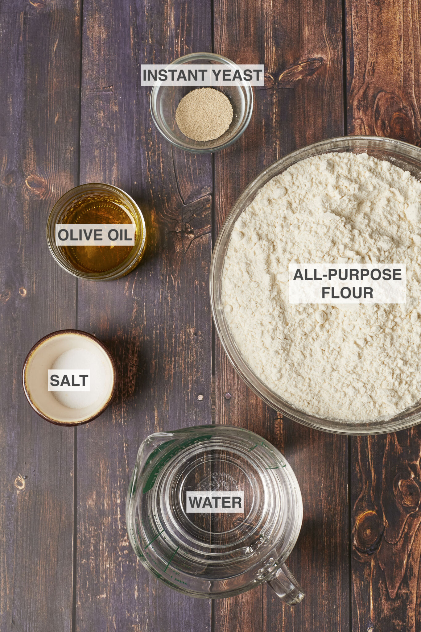 Ingredients for the Easiest Pizza Dough Recipe including all-purpose flour, instant yeast, olive oil, salt, and water. 
