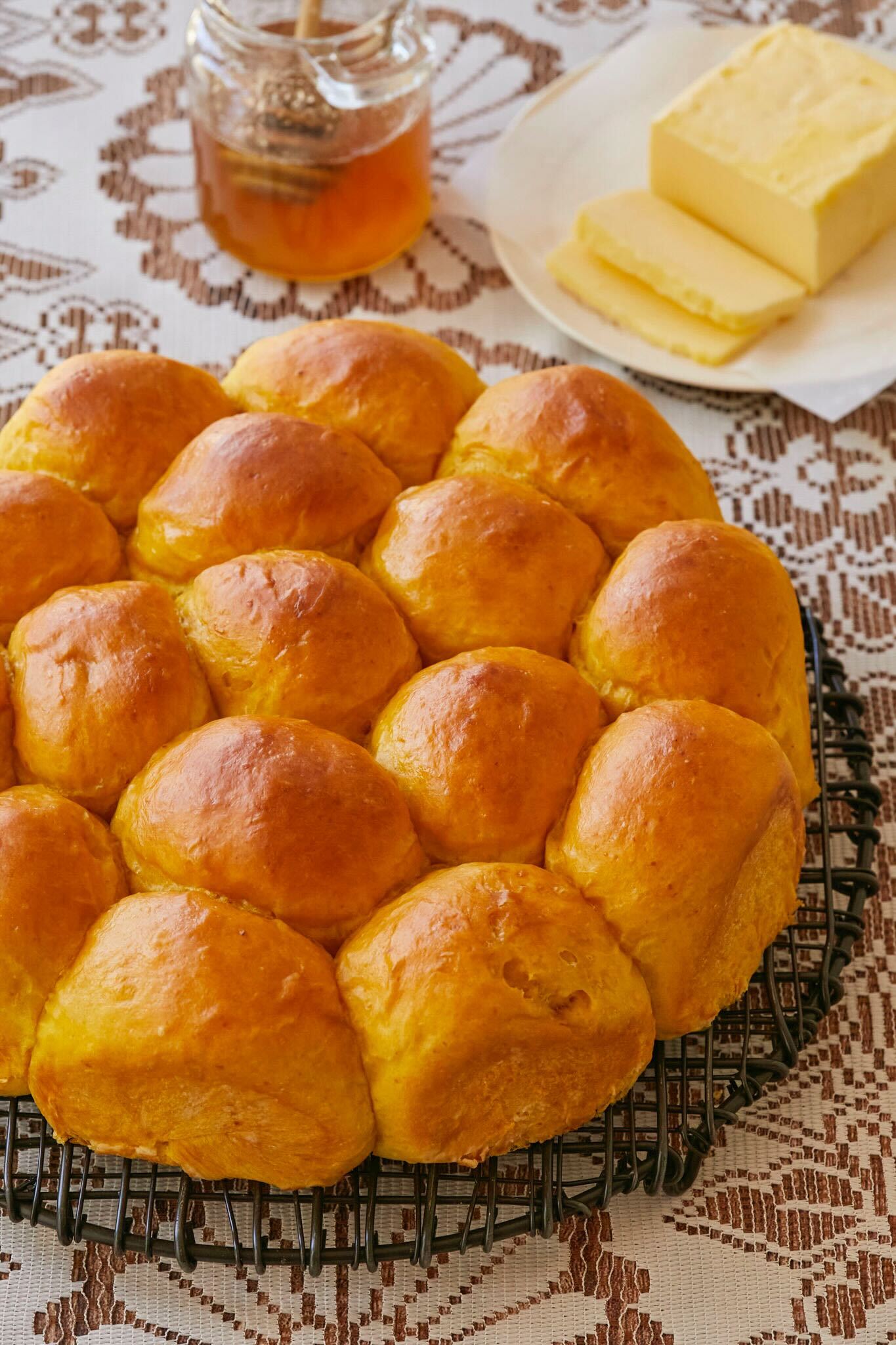 Pumpkin Dinner Rolls look stunning with golden orange color, are slightly crisp on the outside and tender and fluffy on the inside. Served with honey and butter. 
