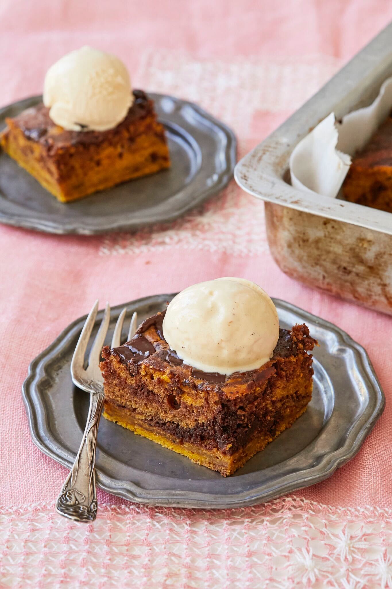 Marbled Pumpkin Pie Brownies are topped with velvety vanilla ice cream. The Rich, chocolatey brownies are swirled together with perfectly spiced pumpkin pie 