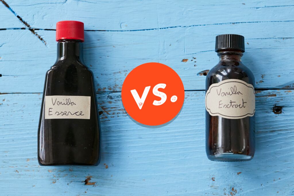 A bottle of Vanilla Essence with a red cap is next to a bottle of vanilla extract with a black cap for comparison.